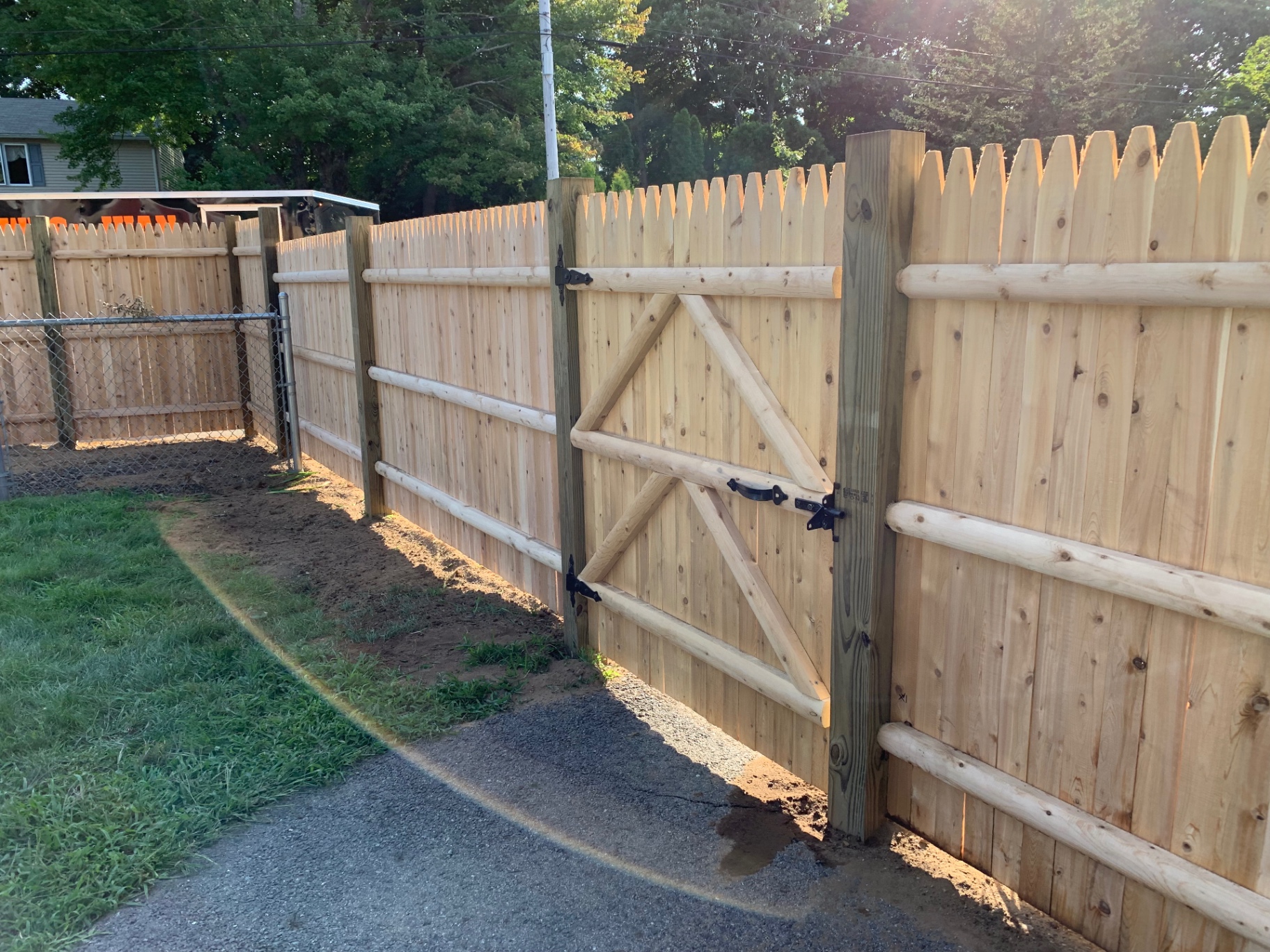 Cedar stockade fence with matching gate and log rails